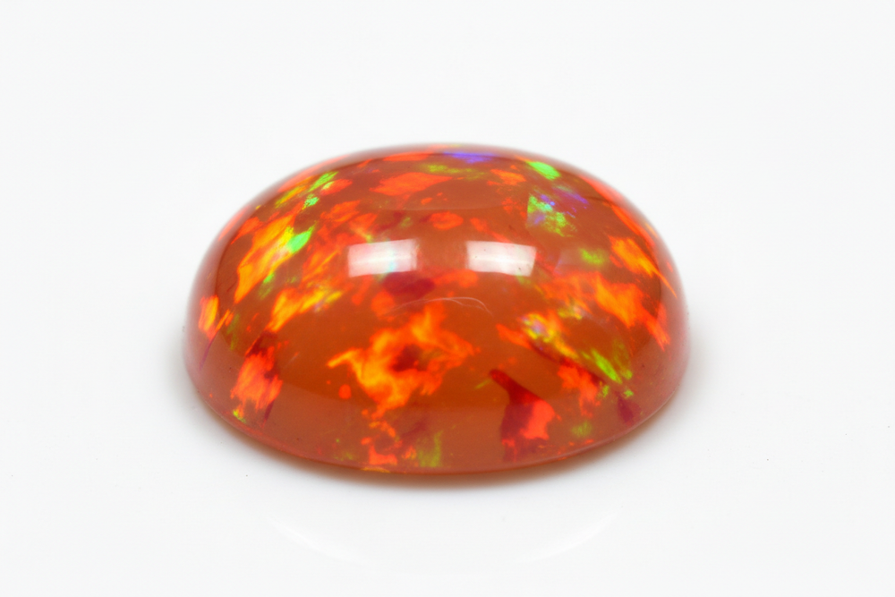 Cabochon fire opal white background