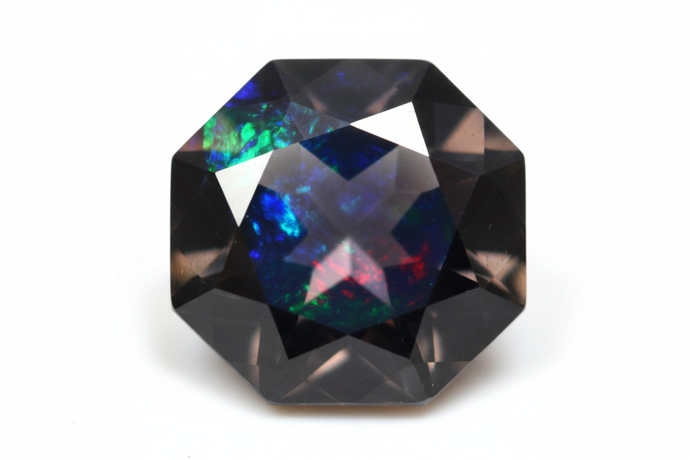 Faceted black opal gemstone octagon shaped white background