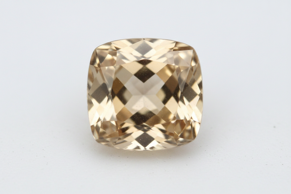 faceted champaign color zircon cushion cut white background
