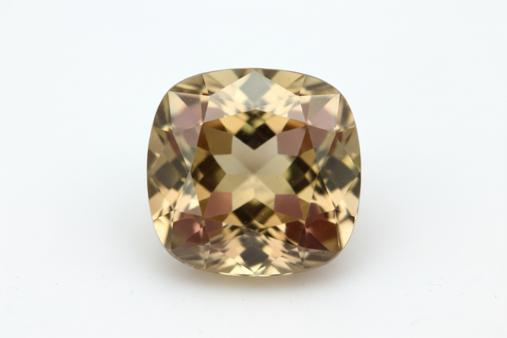 Faceted diaspore gemstone cushion cut white background