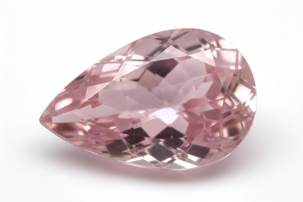 Faceted rose quartz pear shaped checkered cut white background