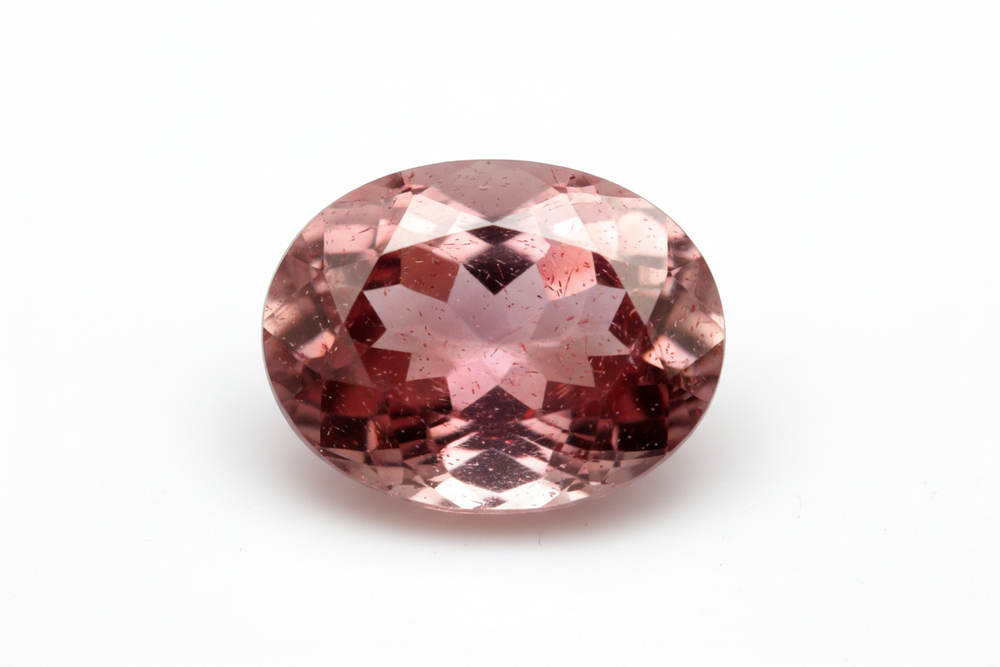 faceted strawberry quartz oval cut white background