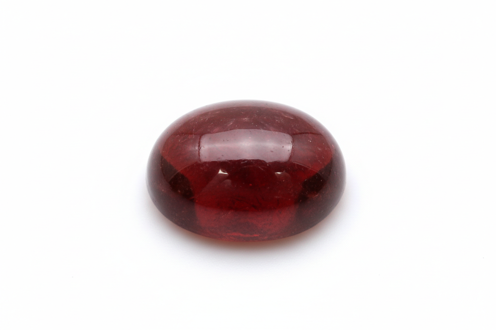 garnet cabochon oval shaped white background