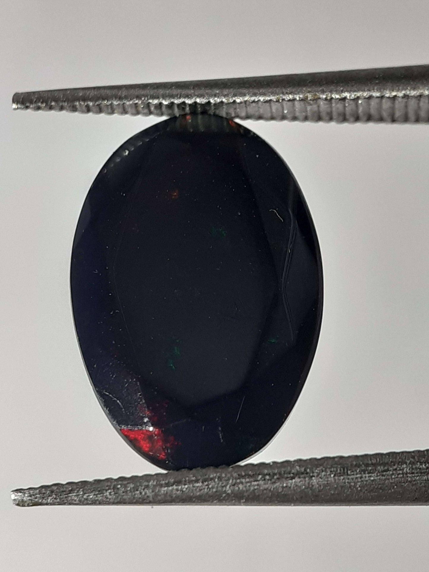 Natural Black Crystal Opal - play of color - 1.892 ct - oval - smoked