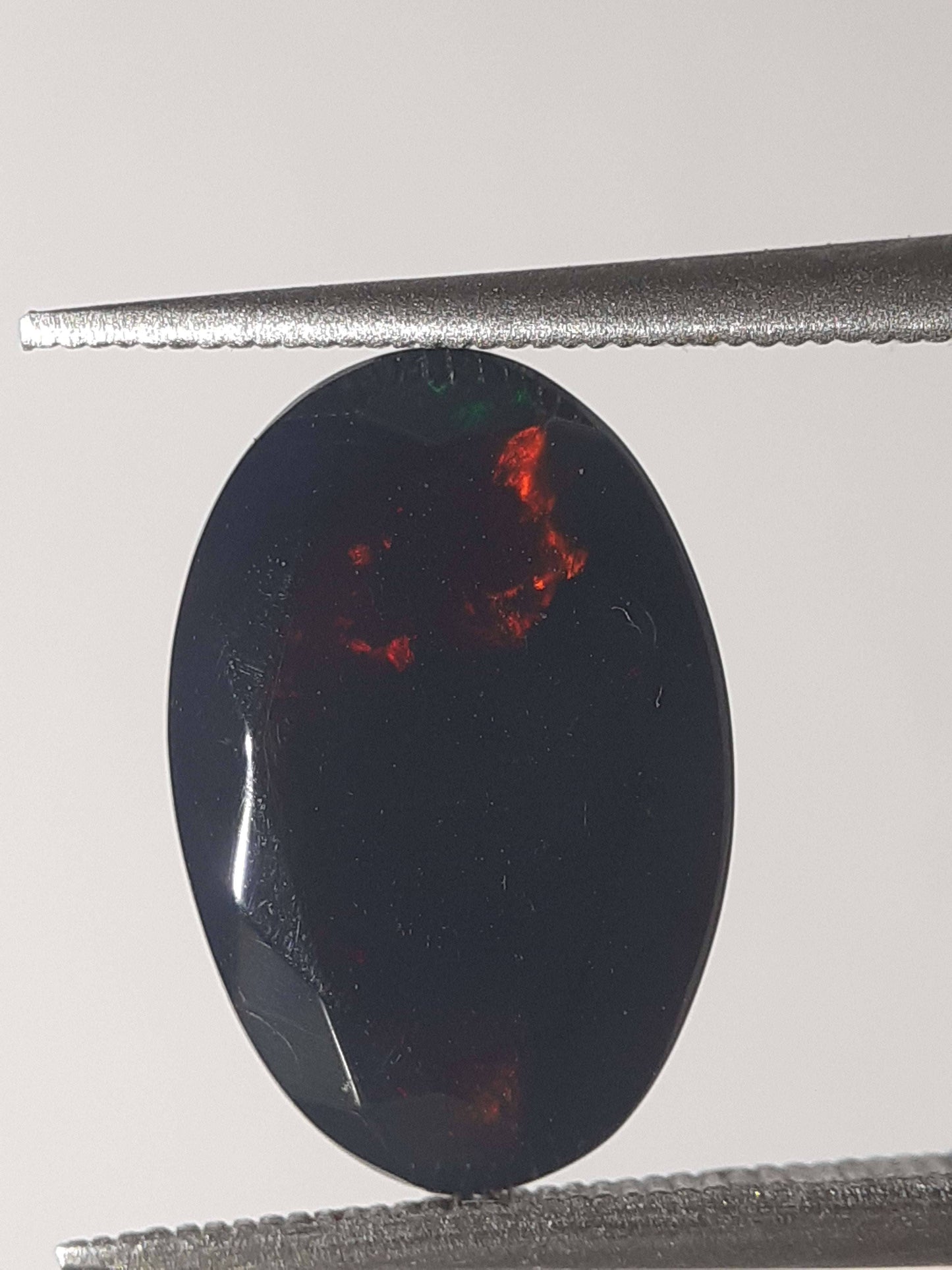 Natural Black Crystal Opal - play of color - 1.892 ct - oval - smoked