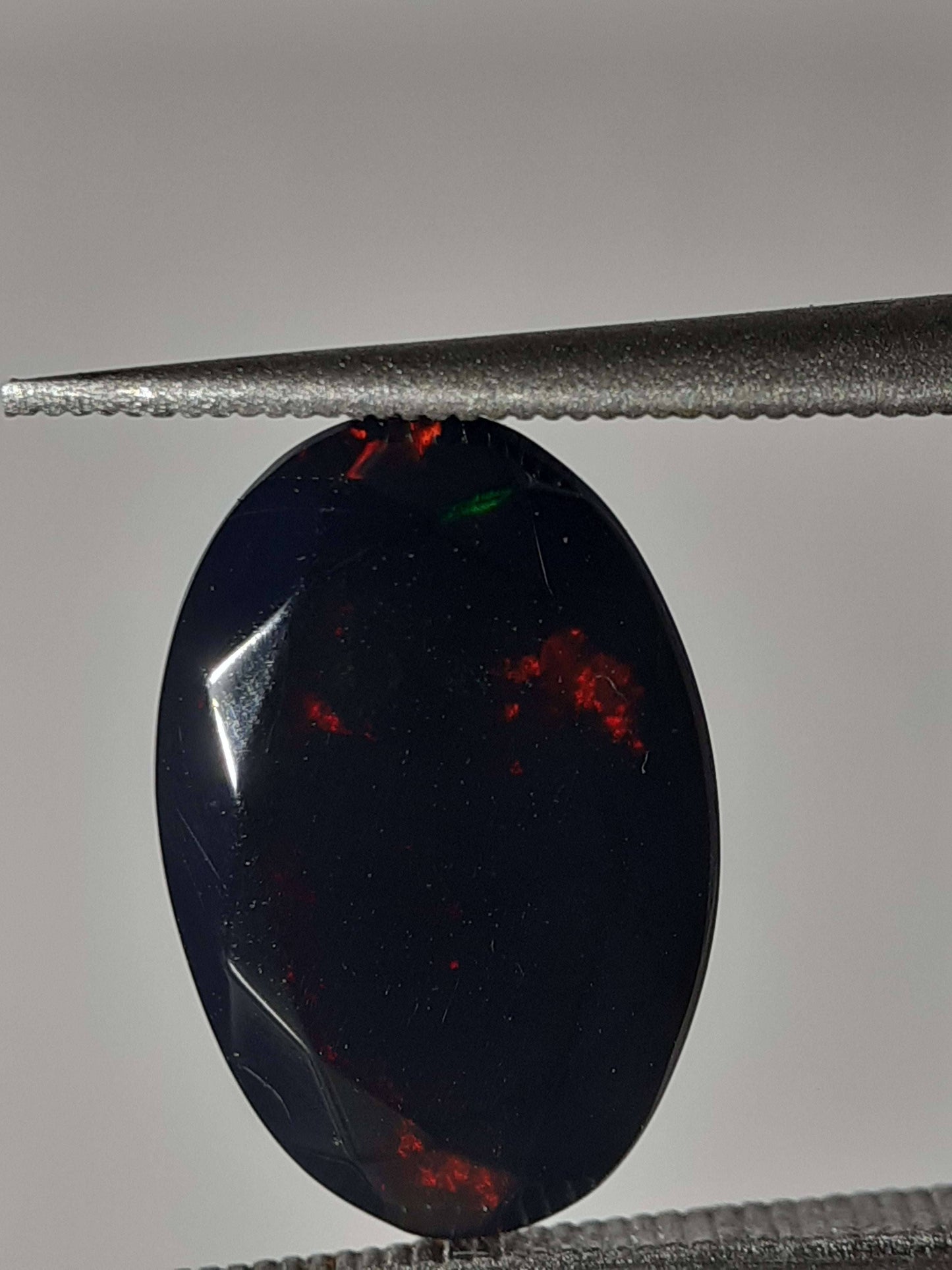 Natural Black Crystal Opal - play of color - 1.892 ct - oval - smoked