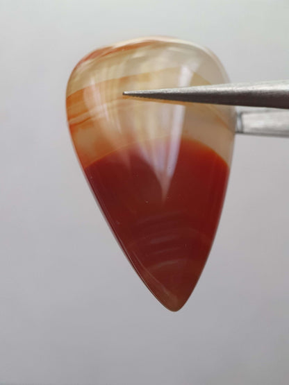 Natural deep brownish red and orange Lake Superior Agate - 23.96 ct - pear Cabochon - unheated - certified by NGB