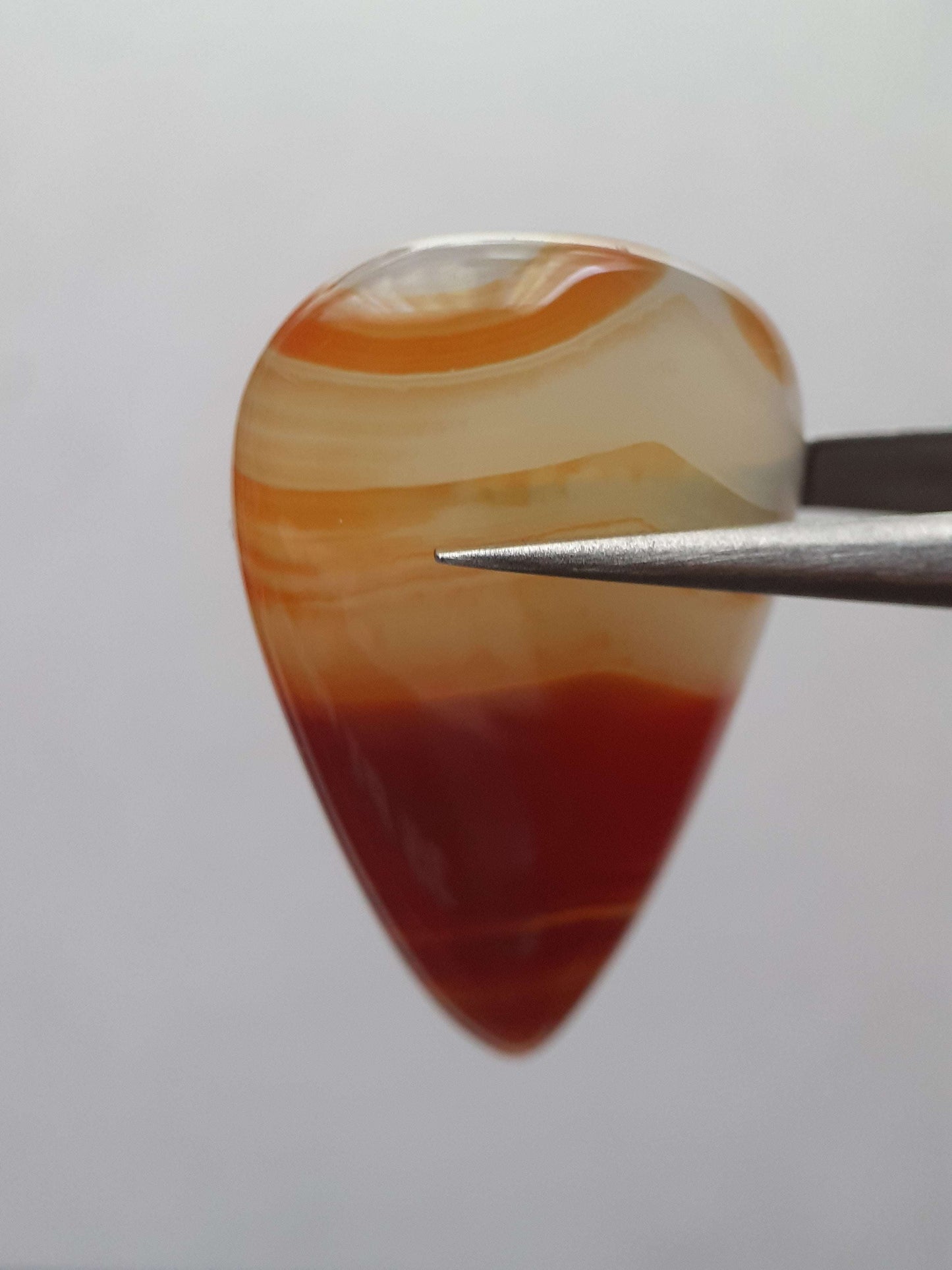 Natural deep brownish red and orange Lake Superior Agate - 23.96 ct - pear Cabochon - unheated - certified by NGB