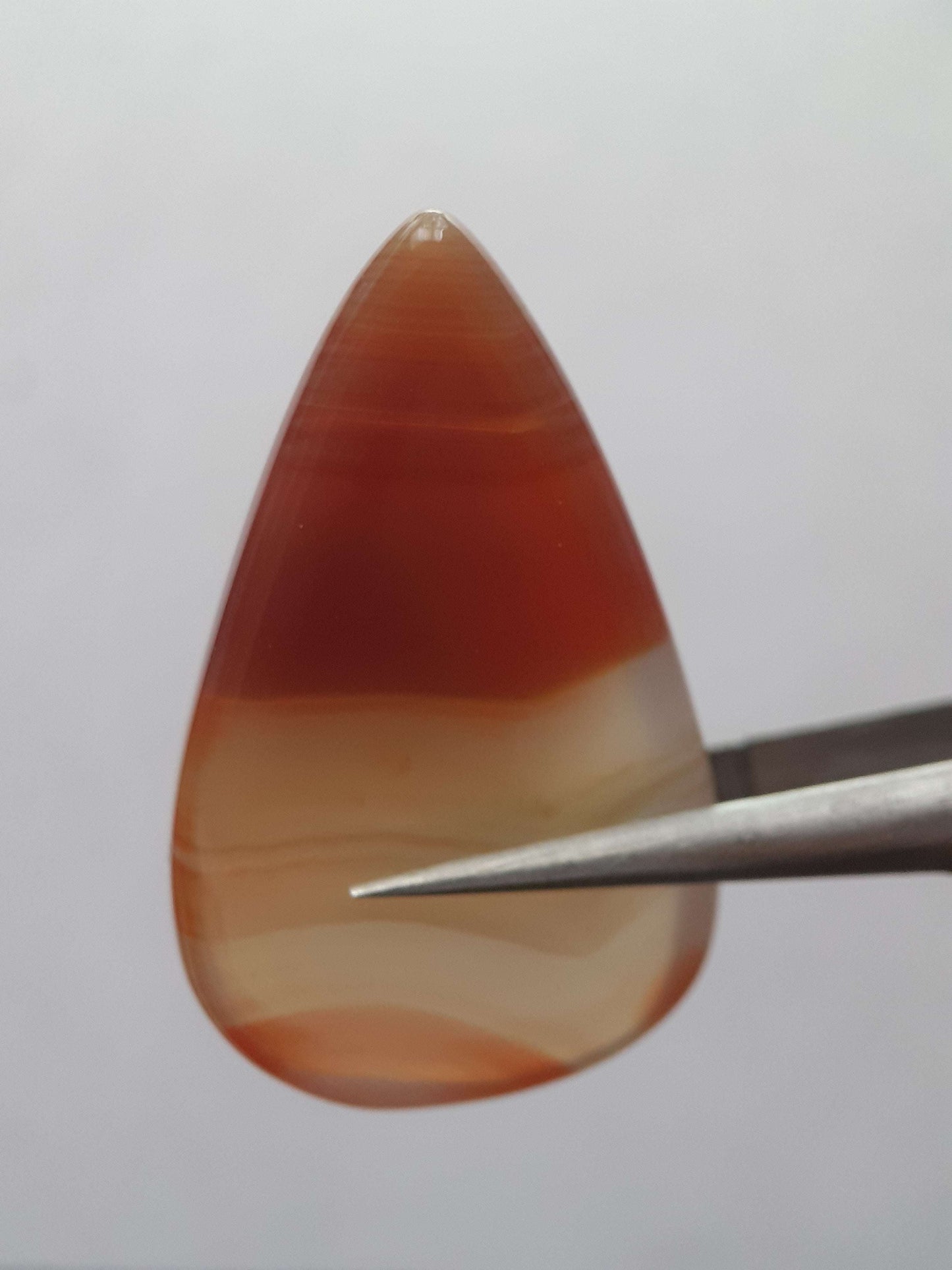 Natural deep brownish red and orange Lake Superior Agate - 23.96 ct - pear Cabochon - unheated - certified by NGB