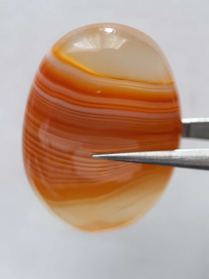 Natural orangy red Lake Superior Agate - 37.78 ct - oval Cabochon - unheated - certified by NGB